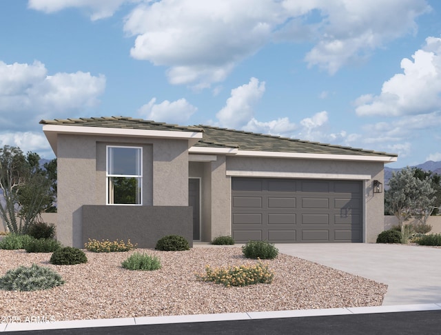 view of front of property with stucco siding, driveway, and an attached garage