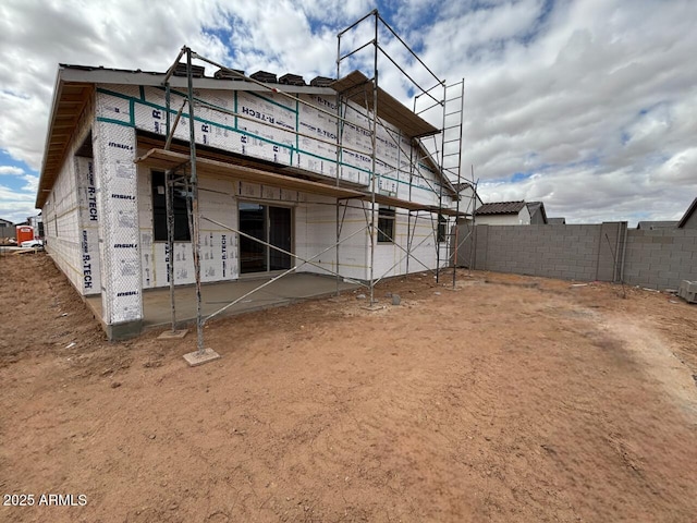 back of house featuring a patio area and fence