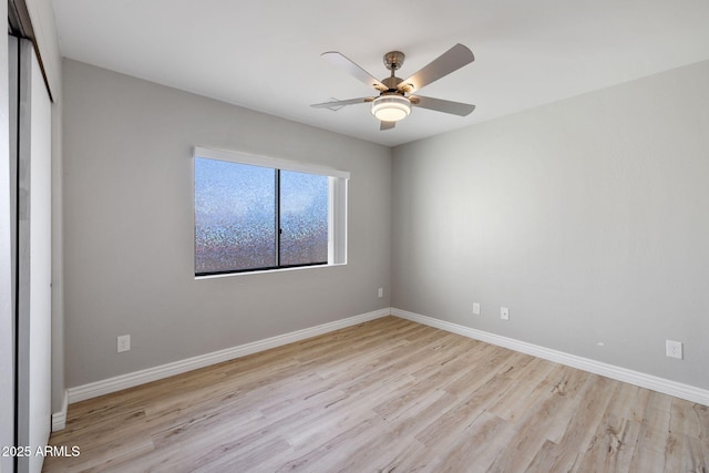 empty room featuring baseboards and wood finished floors