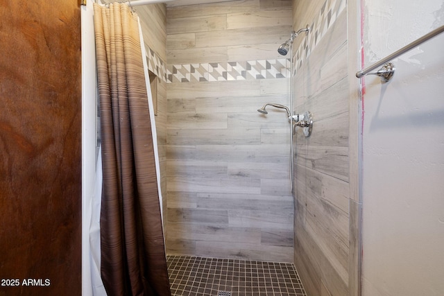 bathroom with a tile shower