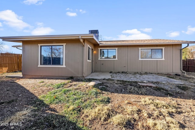 back of property with a patio area and fence