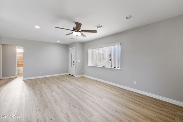 spare room with recessed lighting, a ceiling fan, light wood-style floors, visible vents, and baseboards