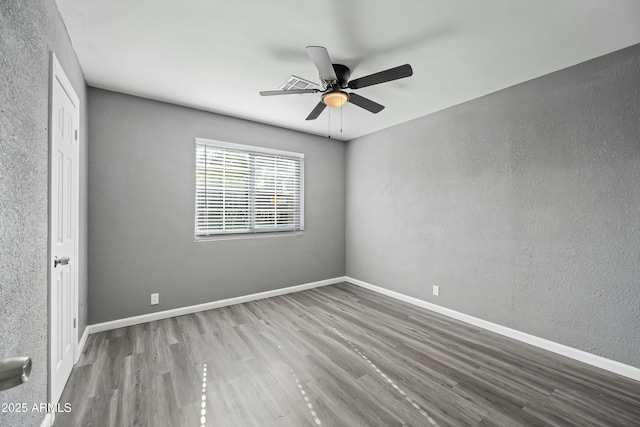 empty room featuring ceiling fan and wood-type flooring