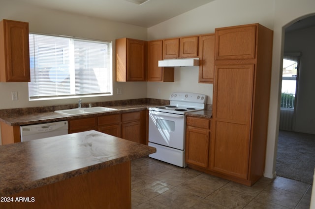 kitchen featuring sink, vaulted ceiling, white appliances, and light tile patterned floors