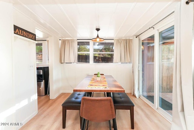 dining area with light wood-type flooring and a healthy amount of sunlight