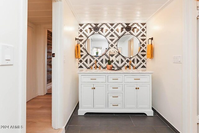 bathroom featuring wood-type flooring, crown molding, and vanity