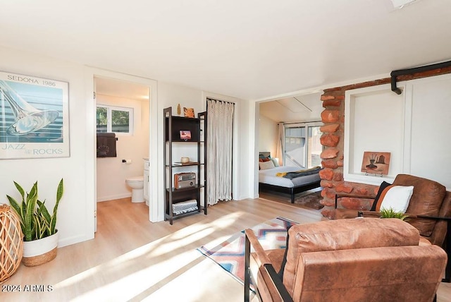 living room with light hardwood / wood-style flooring and a barn door