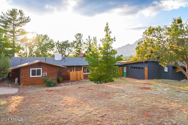 ranch-style house with a garage and a mountain view