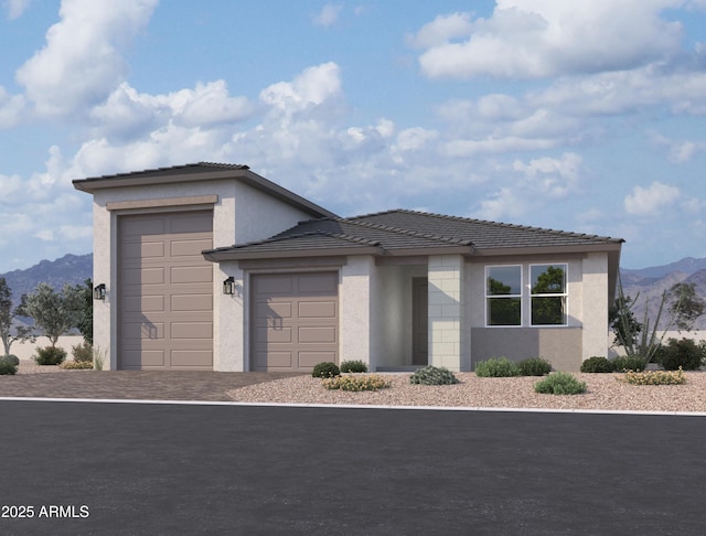 view of front facade featuring a mountain view and a garage