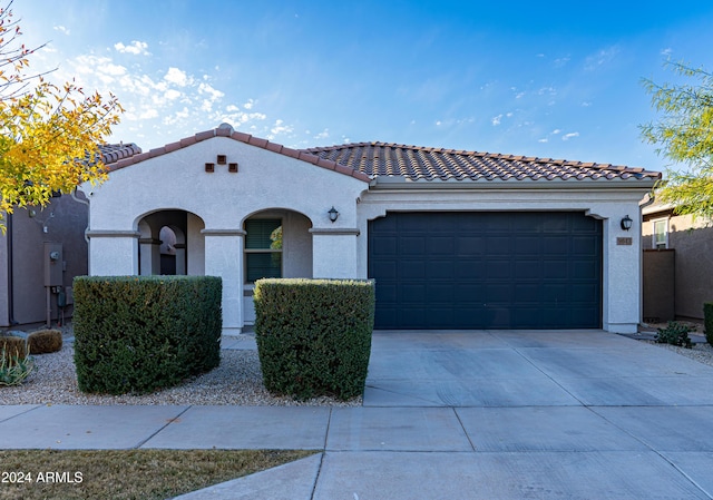 mediterranean / spanish house with a garage