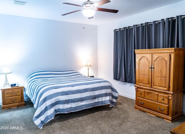 bedroom with ceiling fan and dark colored carpet