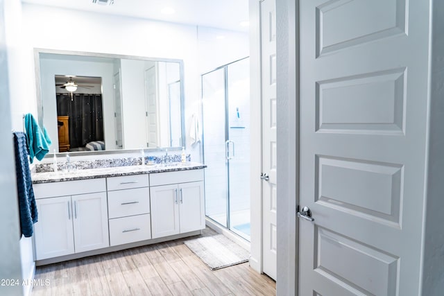 bathroom featuring hardwood / wood-style floors, vanity, walk in shower, and ceiling fan