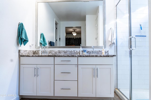 bathroom featuring vanity, a shower with door, and ceiling fan