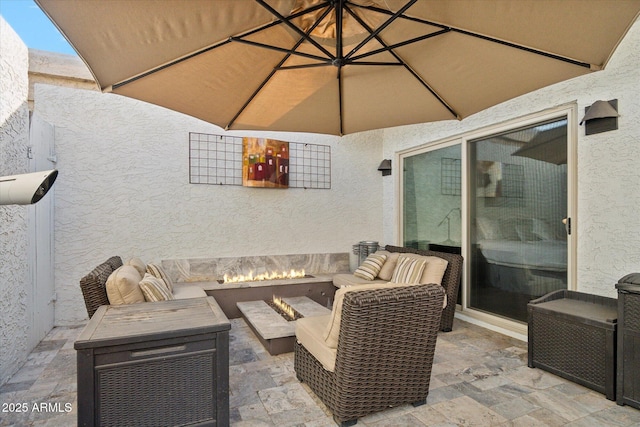 view of patio / terrace featuring an outdoor living space with a fire pit