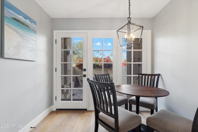 dining area with an inviting chandelier and light wood-type flooring