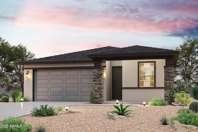 prairie-style home featuring a tiled roof, concrete driveway, stucco siding, stone siding, and an attached garage