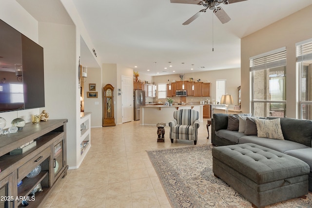 living room with light tile patterned floors and ceiling fan