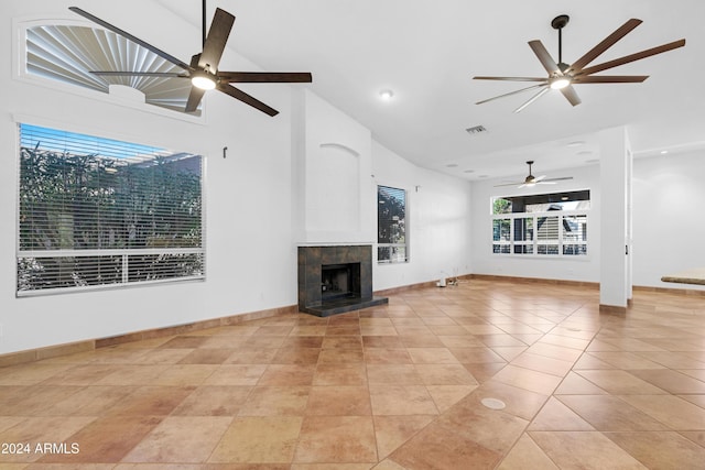 unfurnished living room with light tile patterned floors, a fireplace, high vaulted ceiling, and ceiling fan