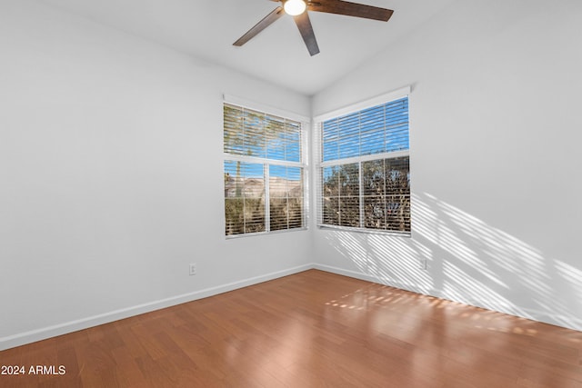 spare room featuring lofted ceiling, hardwood / wood-style flooring, and ceiling fan