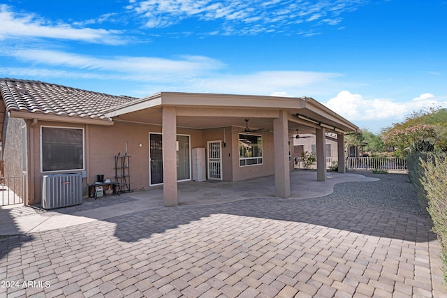 rear view of house featuring central AC unit, ceiling fan, and a patio area