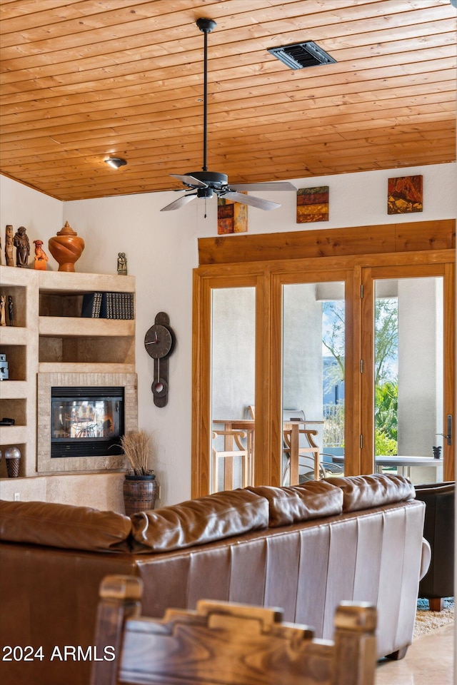 living room featuring ceiling fan, wooden ceiling, and lofted ceiling