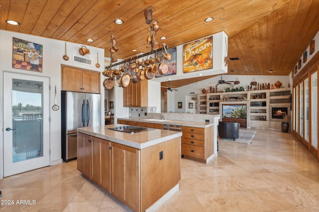 kitchen with stainless steel refrigerator, a kitchen island, and wooden ceiling