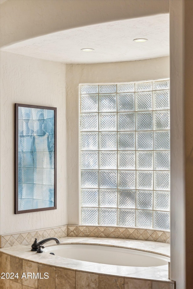 bathroom with tiled tub