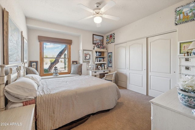 carpeted bedroom with ceiling fan and a closet