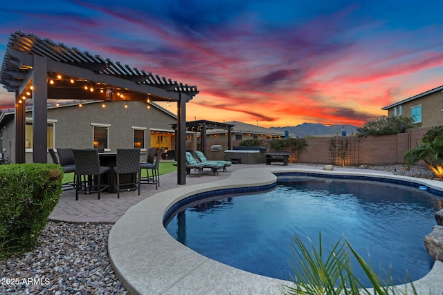 pool at dusk featuring a patio, fence, a fenced in pool, a pergola, and a hot tub