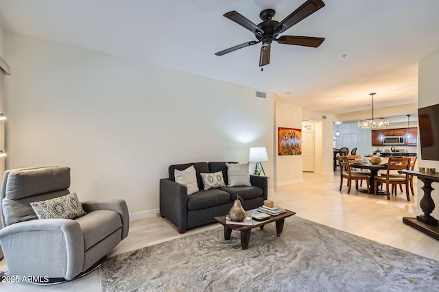 8653 E Royal Palm Rd Unit 1030, Scottsdale, AZ 85258 - living room with ceiling fan and a chandelier