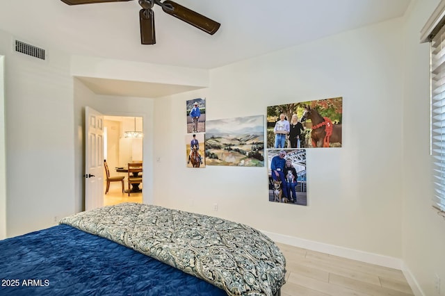 8653 E Royal Palm Rd Unit 1030, Scottsdale, AZ 85258 - bedroom with wood finished floors and a ceiling fan