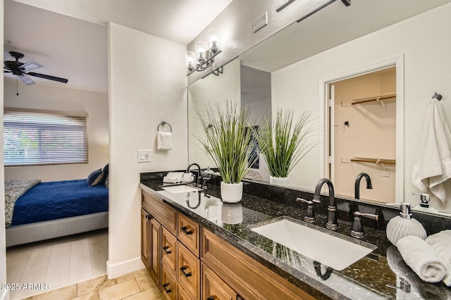 8653 E Royal Palm Rd Unit 1030, Scottsdale, AZ 85258 - full bathroom with double vanity, connected bathroom, and ceiling fan