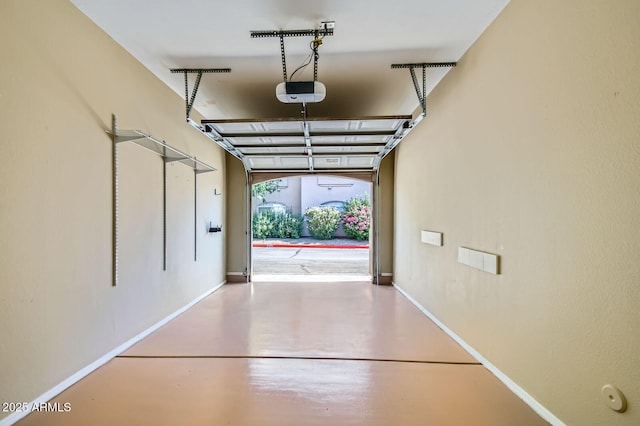8653 E Royal Palm Rd Unit 1030, Scottsdale, AZ 85258 - garage with a garage door opener and baseboards