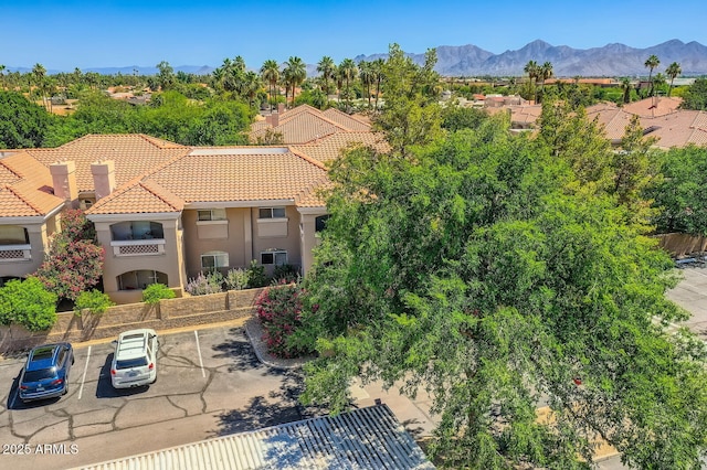 8653 E Royal Palm Rd Unit 1030, Scottsdale, AZ 85258 - view of front of house with uncovered parking, a tiled roof, stucco siding, and a mountain view