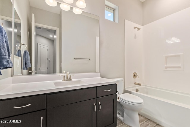 full bath featuring toilet, shower / bath combination, wood finished floors, and vanity