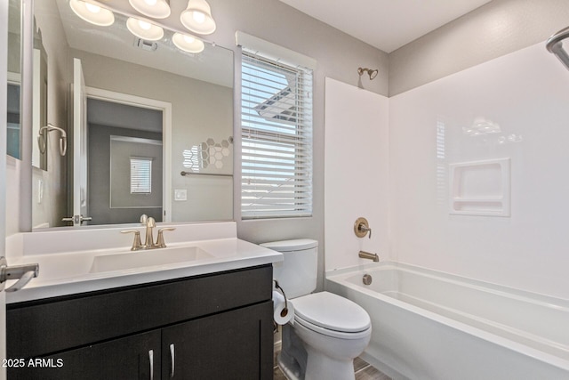 bathroom with visible vents, shower / washtub combination, vanity, and toilet