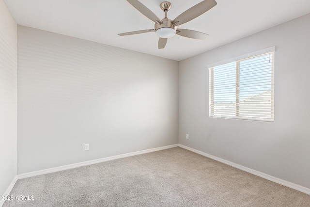 spare room featuring ceiling fan, carpet floors, and baseboards