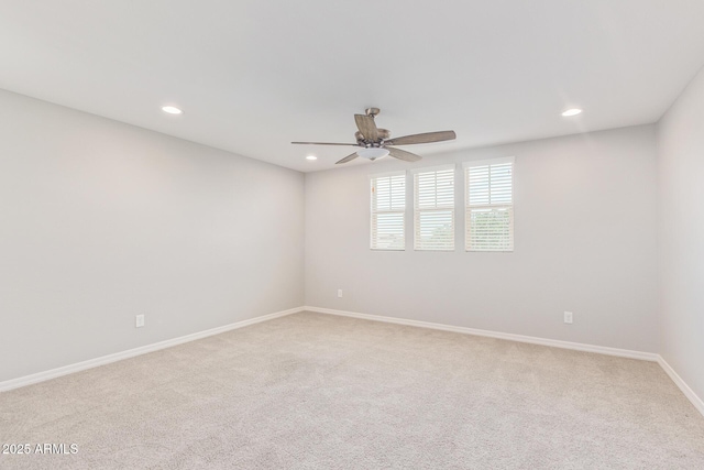 empty room with recessed lighting, light colored carpet, ceiling fan, and baseboards