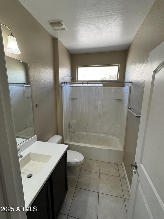 bathroom with visible vents, tile patterned flooring, shower / washtub combination, vanity, and toilet