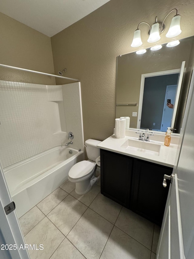 bathroom with tile patterned flooring, vanity, toilet, bathing tub / shower combination, and a textured wall