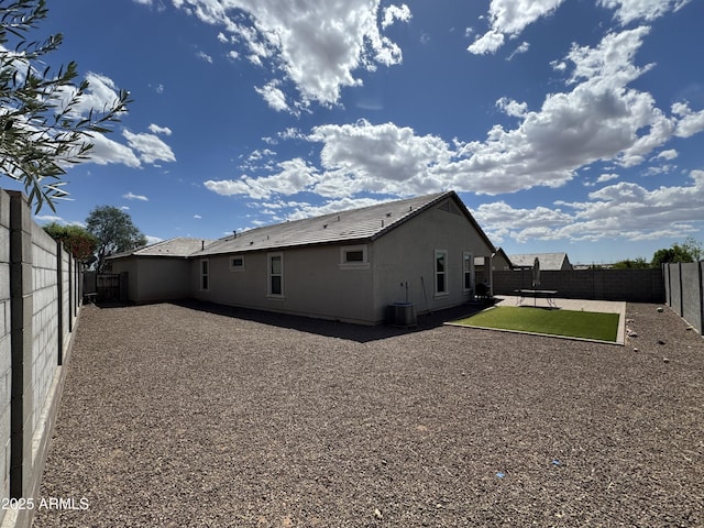 back of house with a patio, a fenced backyard, and central air condition unit