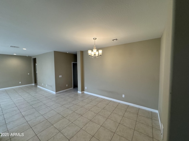 spare room with an inviting chandelier, recessed lighting, light tile patterned floors, and visible vents