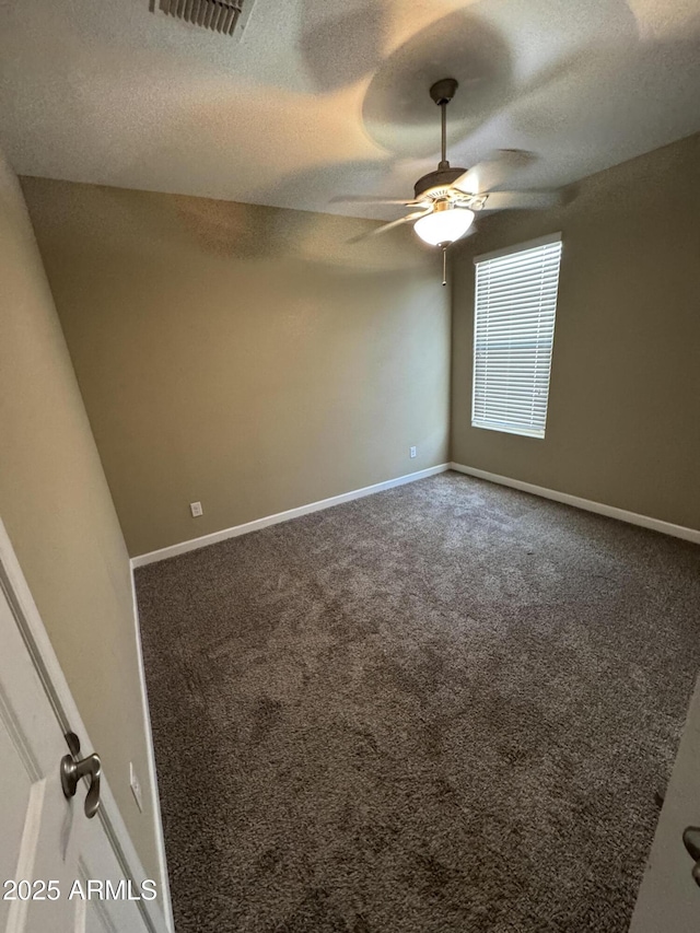 carpeted empty room featuring baseboards, a ceiling fan, a textured ceiling, and visible vents