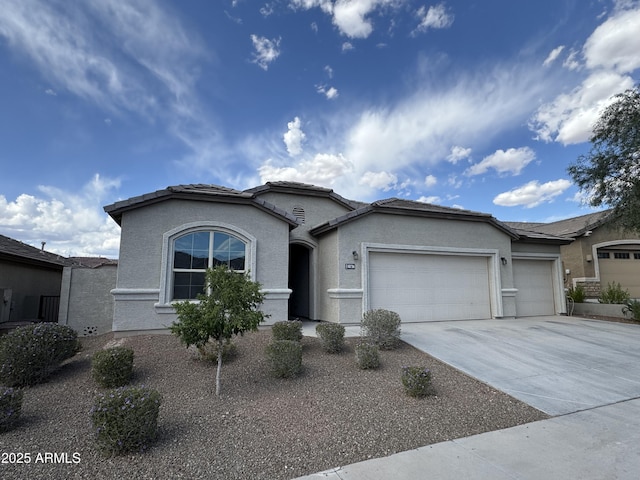 single story home featuring a garage, stucco siding, and concrete driveway