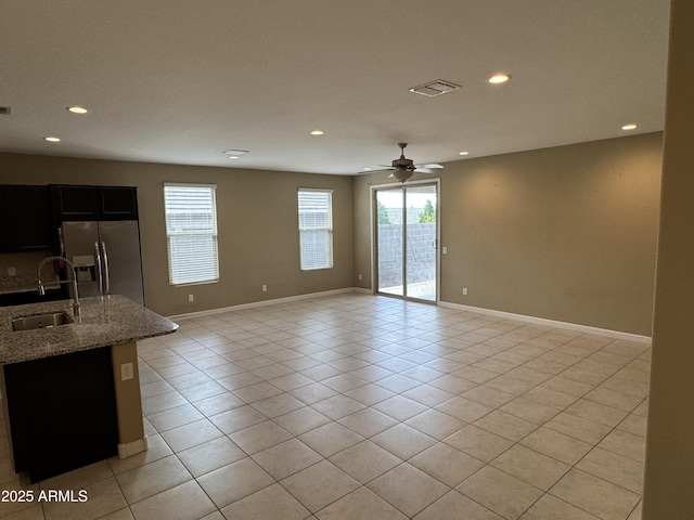 interior space featuring a sink, recessed lighting, light tile patterned flooring, and visible vents