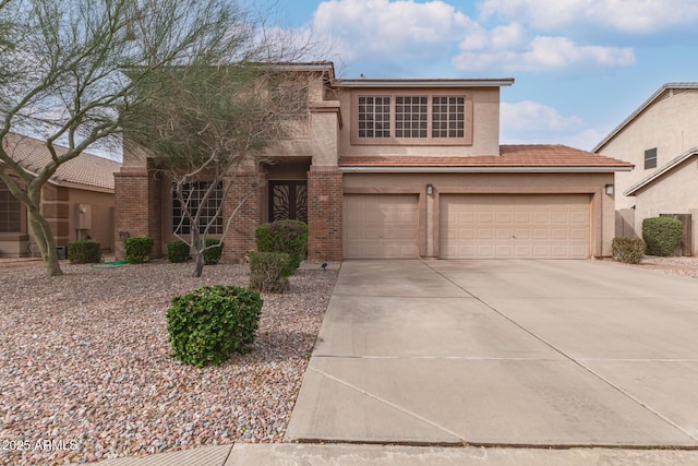 view of front of house featuring brick siding, stucco siding, concrete driveway, and a garage