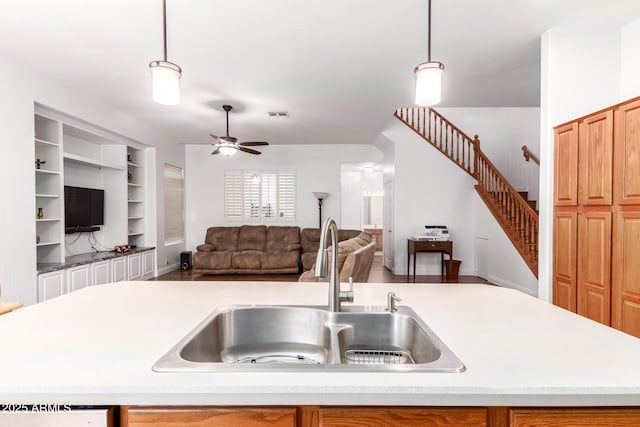 kitchen featuring a sink, visible vents, a ceiling fan, and light countertops