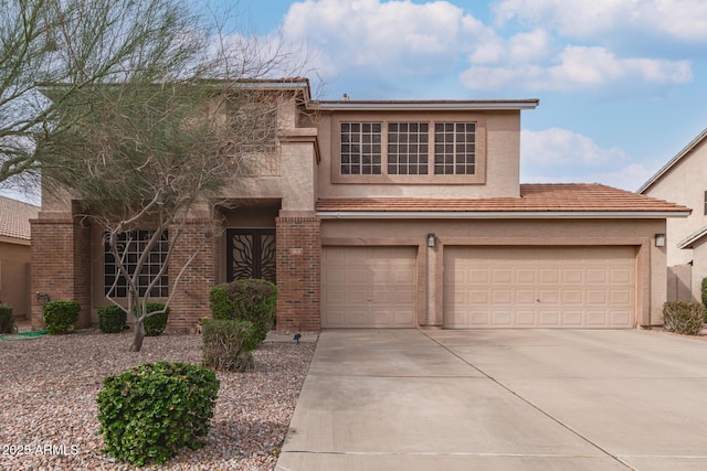 traditional-style home featuring stucco siding, concrete driveway, and an attached garage