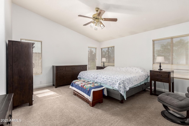 bedroom featuring light carpet, baseboards, ceiling fan, and vaulted ceiling