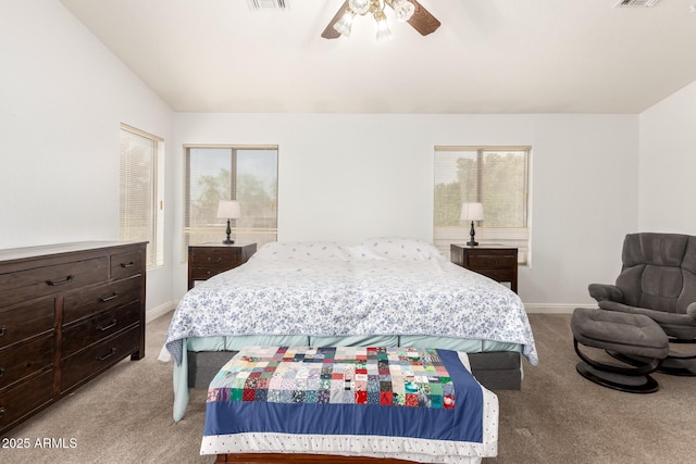 bedroom featuring visible vents, light carpet, baseboards, and ceiling fan